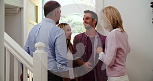 Senior Parents Welcoming Visiting Adult Children At Front Door