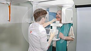 Senior patient examination of teeth by using panoramic and cephalometric X-Ray scanner photo