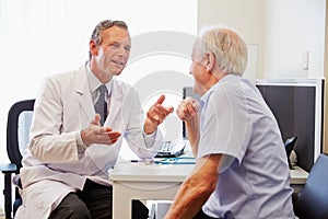 Senior Patient Having Consultation With Doctor In Office