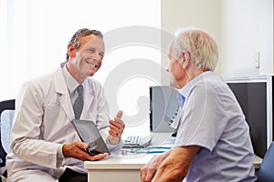 Senior Patient Having Consultation With Doctor In Office