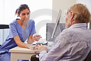Senior Patient Having Consultation With Nurse In Office