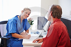 Senior Patient Having Consultation With Nurse In Office