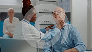 Senior patient having medical checkup appointment with doctor