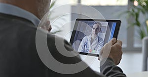 Senior patient having a video chat consultation with his doctor