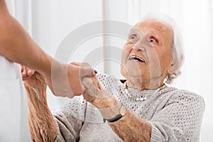Senior Patient Holding Hands Of Female Doctor