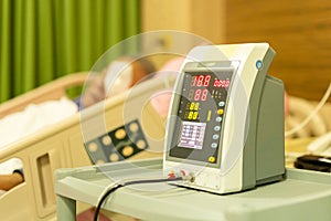 Senior patient in hospital bed checking blood pressure health care.