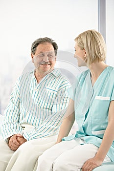 Senior patient in hospital with nurse