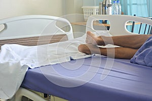 Senior patient lying on the bed in the patient room at the hospital