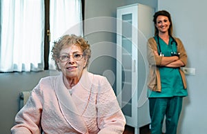 Senior patient posing with doctor in the background