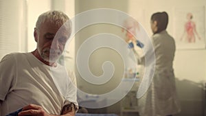 Senior patient preparing get injection vaccine in doctor office close up.