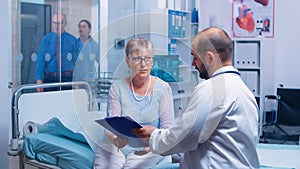 Senior patient signing medical decisions