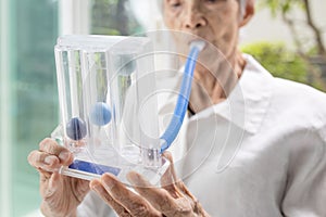 Senior patient using incentive spirometer,tool to help the lung expansion,exercise the lung,old elderly with Tuberculosis,Asthma,