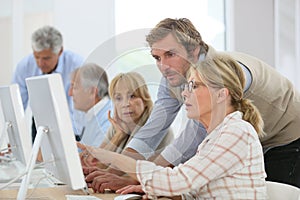 Senior people attending computing class