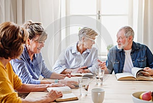 Senior people in bible reading group in community center club.