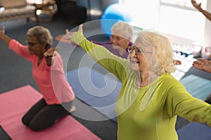 Senior people exercising in fitness studio