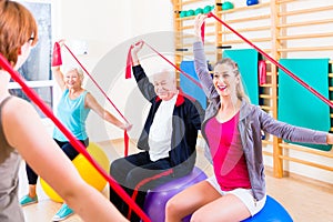 Senior people at fitness course in gym