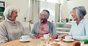 Senior people, friends and drinking tea and talking at a table in a retirement home. Elderly women and a man at a table