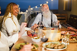 Senior people having fun at patio dinner party - Focus on hipster male face