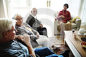 Senior people sitting together in a living room photo
