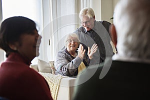 Senior people talking in a living room photo