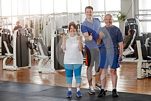 Senior people with trainer at fitness club.