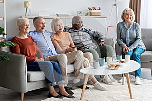Senior people watching television in the living room