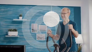 Senior person doing physical exercise on stationary bicycle