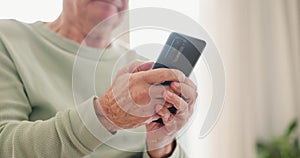 Senior person, Parkinson hands and phone text on app, social media and internet scroll at a retirement home. Technology