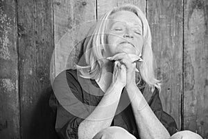 Senior person pray with a wood background