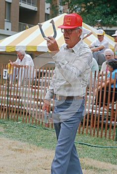 A senior playing a game of horseshoes