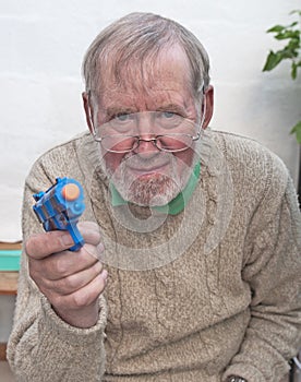 Senior playing with toy gun