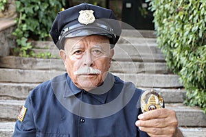 Senior police showing his badge