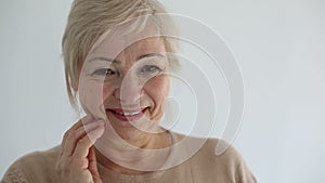 Senior portrait, happy old woman smiling and looking at camera. Slow motion