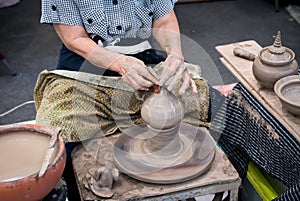 Senior potter& x27;s hands shaping decorative clay hollow sculpture t