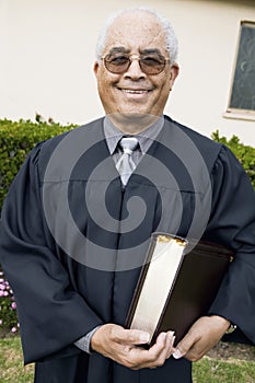 Senior Preacher in garden with Bible portrait