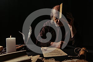 senior priest obscuring face with bible