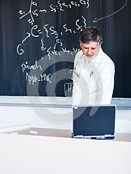 Senior professor writing on the board