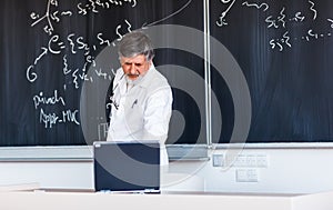 Senior professor writing on the board