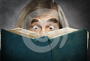 Senior reading open book, surprised old man, amazi
