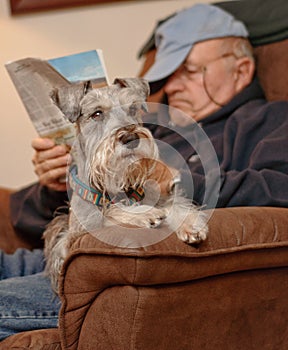 Senior Reading and Relaxing with Dog