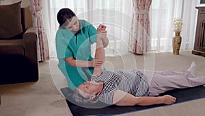 Senior during rehabilitation with physiotherapist after an arm injury