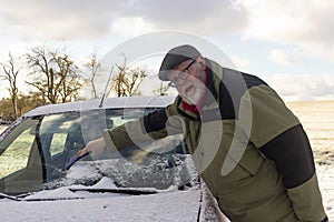 Senior remove car from hoarfrost