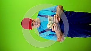 Senior repairman counting cash of 100 dollars banknotes and angrily returns it.