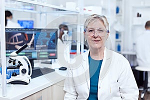 Senior researcher sits at her workplace in laboratory