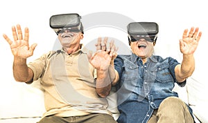 Senior retired couple having fun together with virtual reality glasses