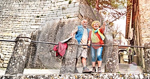 Senior retired couple having genuine fun in San Marino old town castle - Active elderly and travel lifestyle concept