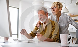 Senior retired couple learn about computer and online support.