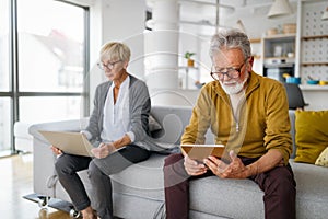 Senior retired couple learn about computer and online support.