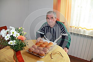 Senior retired man enjoying carnival doughnut