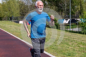 A senior retired man jogging.